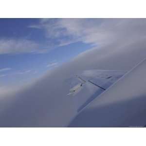  A View of Soft White Clouds and an Airplane Wing 