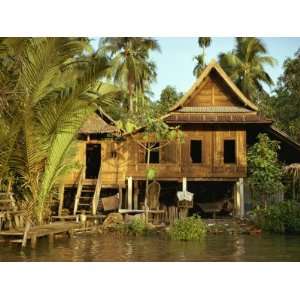 Traditional Thai House on Stilts Above the River in Bangkok, Thailand 