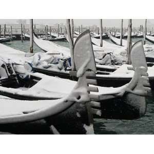 Layer of Fresh Snow Coats Gondolas Moored in Venice, Italy Stretched 