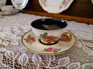 this lovely cup saucer are detailed with dark pink roses and trimmed 