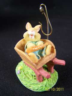Little Easter bunny laughing in a wooden wheelbarrow with redwood 